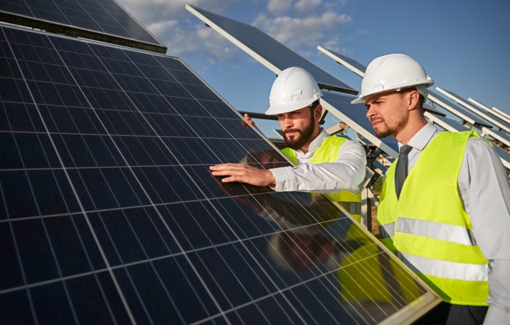 technicians-examining-solar-panels-installation-e1696032530560.jpg